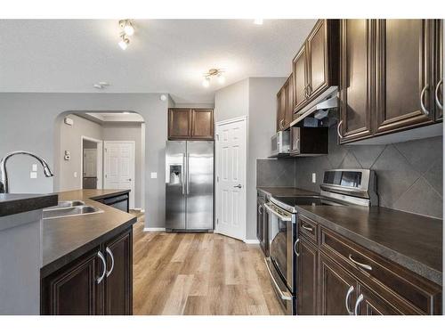 16 Drake Landing Mews, Okotoks, AB - Indoor Photo Showing Kitchen With Double Sink