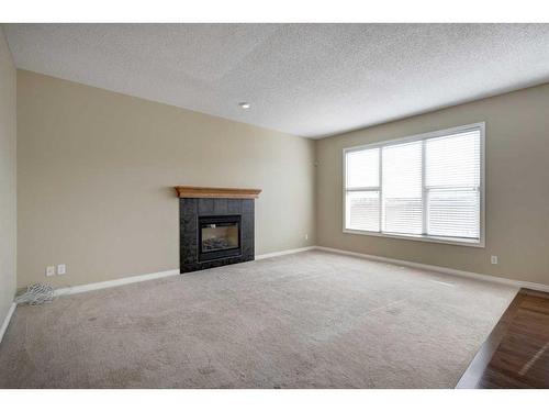 1047 Copperfield Boulevard Se, Calgary, AB - Indoor Photo Showing Living Room With Fireplace