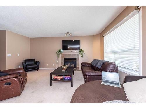 154 Bridlewood Court Sw, Calgary, AB - Indoor Photo Showing Living Room With Fireplace