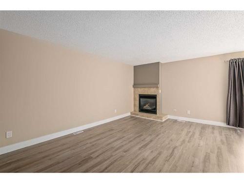 7228 & 7230 Ogden Road Se, Calgary, AB - Indoor Photo Showing Living Room With Fireplace