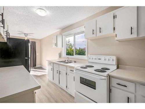 7228 & 7230 Ogden Road Se, Calgary, AB - Indoor Photo Showing Kitchen With Double Sink