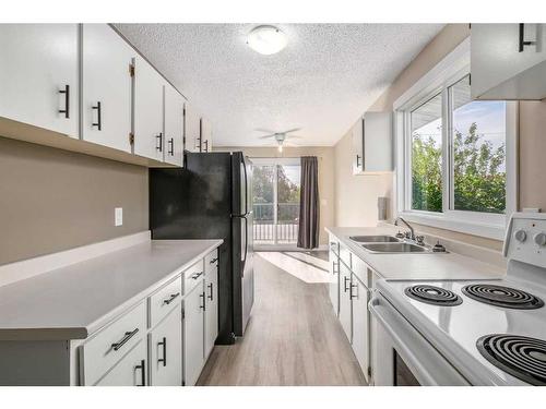 7228 & 7230 Ogden Road Se, Calgary, AB - Indoor Photo Showing Kitchen With Double Sink