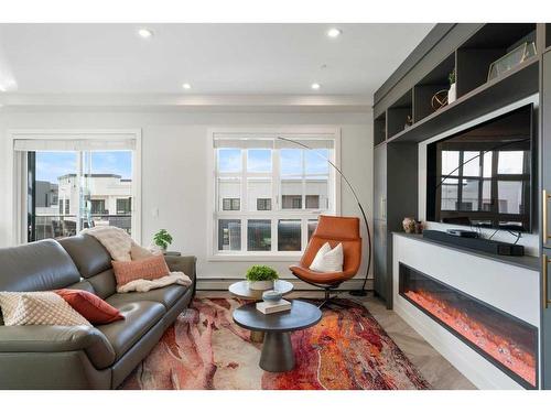 401-4275 Norford Avenue Nw, Calgary, AB - Indoor Photo Showing Living Room With Fireplace