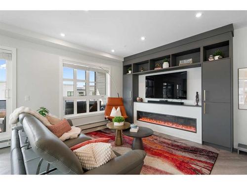 401-4275 Norford Avenue Nw, Calgary, AB - Indoor Photo Showing Living Room With Fireplace