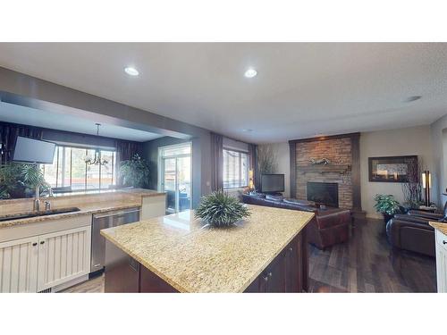 943 Auburn Bay Boulevard Se, Calgary, AB - Indoor Photo Showing Kitchen With Fireplace