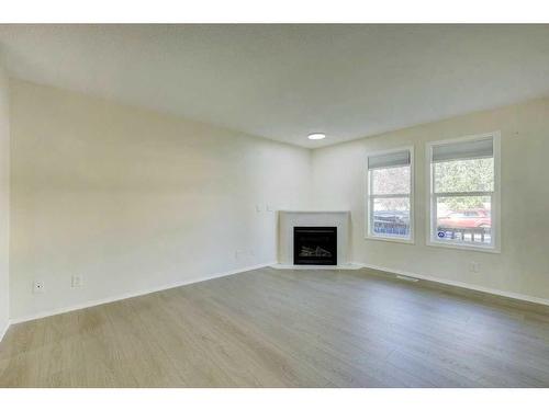 198 Panatella Park Nw, Calgary, AB - Indoor Photo Showing Living Room With Fireplace