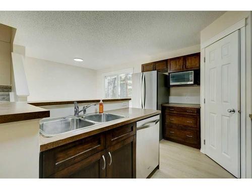 198 Panatella Park Nw, Calgary, AB - Indoor Photo Showing Kitchen With Double Sink