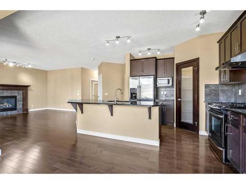 60 Westmount Way, Okotoks, AB - Indoor Photo Showing Kitchen With Fireplace With Upgraded Kitchen