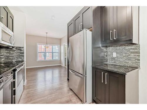 228 Marquis Lane Se, Calgary, AB - Indoor Photo Showing Kitchen With Stainless Steel Kitchen With Upgraded Kitchen