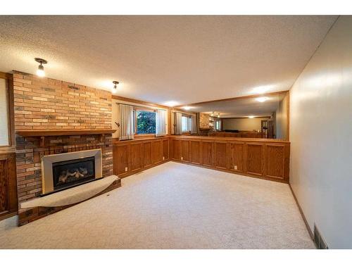 16 Ridgegate Way Sw, Airdrie, AB - Indoor Photo Showing Other Room With Fireplace