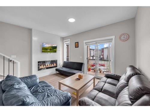 104-95 Skyview Close Ne, Calgary, AB - Indoor Photo Showing Living Room With Fireplace