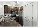 304-10 Panatella Road Nw, Calgary, AB  - Indoor Photo Showing Kitchen With Stainless Steel Kitchen With Double Sink 