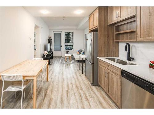 1110-350 Livingston Common Ne, Calgary, AB - Indoor Photo Showing Kitchen With Stainless Steel Kitchen With Double Sink