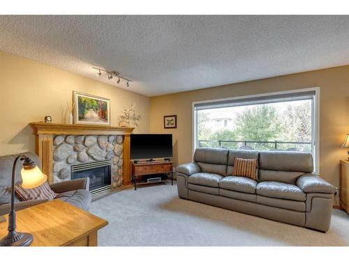 151 Riverview Circle Se, Calgary, AB - Indoor Photo Showing Living Room With Fireplace