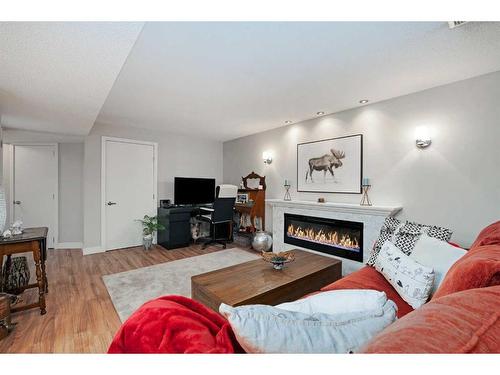 348 Adams Crescent Se, Calgary, AB - Indoor Photo Showing Living Room With Fireplace