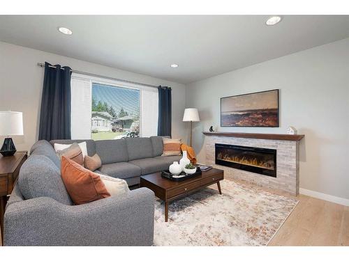 348 Adams Crescent Se, Calgary, AB - Indoor Photo Showing Living Room With Fireplace