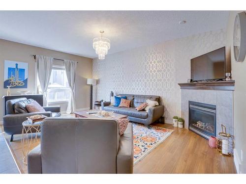 23 Everwoods Park Sw, Calgary, AB - Indoor Photo Showing Living Room With Fireplace