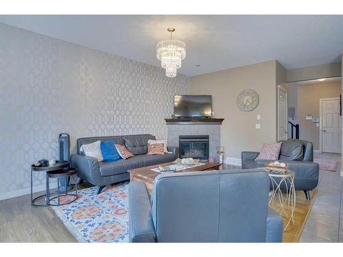 23 Everwoods Park Sw, Calgary, AB - Indoor Photo Showing Living Room With Fireplace