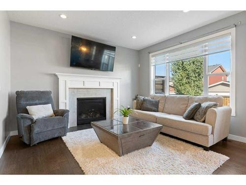 138 Baywater Way Sw, Airdrie, AB - Indoor Photo Showing Living Room With Fireplace