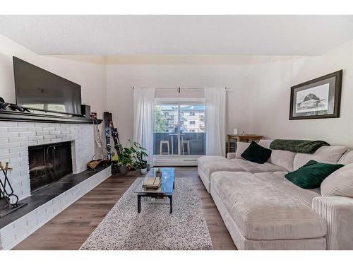 303-730 2 Avenue Nw, Calgary, AB - Indoor Photo Showing Living Room With Fireplace