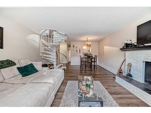 303-730 2 Avenue Nw, Calgary, AB - Indoor Photo Showing Living Room With Fireplace