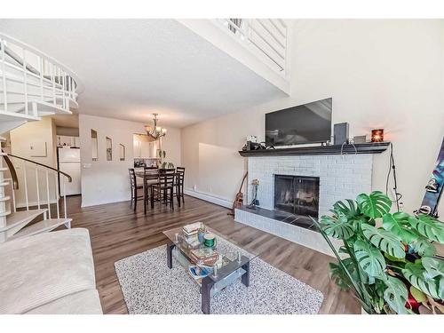 303-730 2 Avenue Nw, Calgary, AB - Indoor Photo Showing Living Room With Fireplace