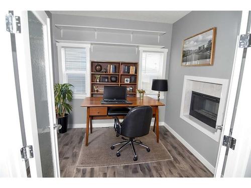 177 Baysprings Gardens Sw, Airdrie, AB - Indoor Photo Showing Office With Fireplace