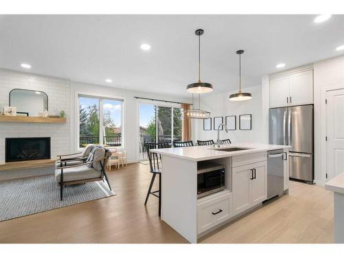 55 Shawnee Heath Sw, Calgary, AB - Indoor Photo Showing Kitchen With Fireplace With Stainless Steel Kitchen With Upgraded Kitchen