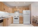 206-2206 Hawksbrow Point Nw, Calgary, AB  - Indoor Photo Showing Kitchen With Double Sink 