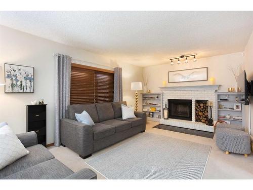 57 Shannon Crescent Sw, Calgary, AB - Indoor Photo Showing Living Room With Fireplace