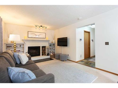 57 Shannon Crescent Sw, Calgary, AB - Indoor Photo Showing Living Room With Fireplace