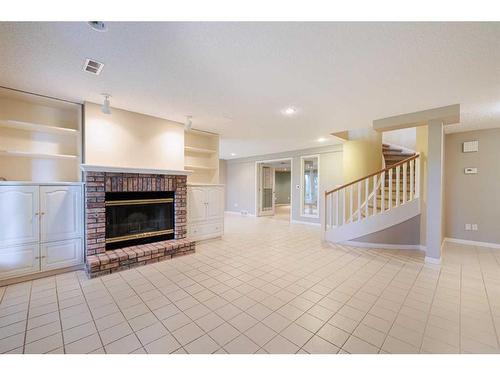 36 Sunrise Way, Priddis Greens, AB - Indoor Photo Showing Living Room With Fireplace