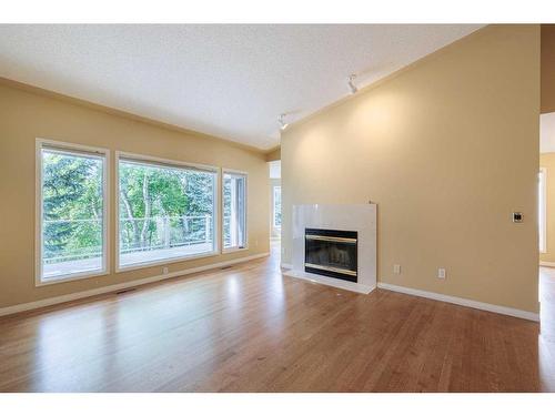 36 Sunrise Way, Priddis Greens, AB - Indoor Photo Showing Living Room With Fireplace