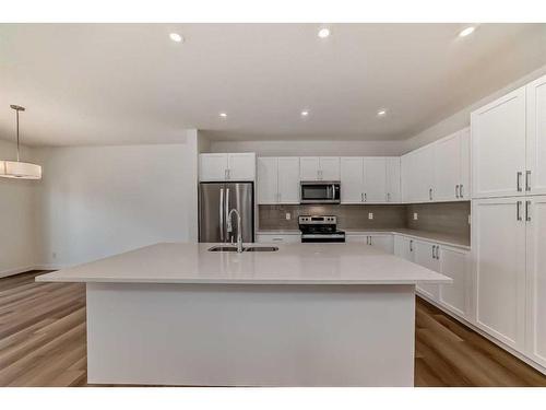 325 Baneberry Way Sw, Airdrie, AB - Indoor Photo Showing Kitchen With Stainless Steel Kitchen With Double Sink With Upgraded Kitchen