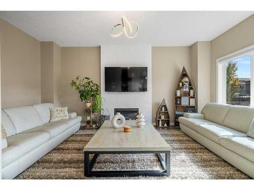 249 Walden Heights Se, Calgary, AB - Indoor Photo Showing Living Room With Fireplace