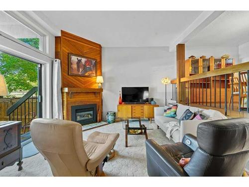 419-3131 63 Avenue Sw, Calgary, AB - Indoor Photo Showing Living Room With Fireplace