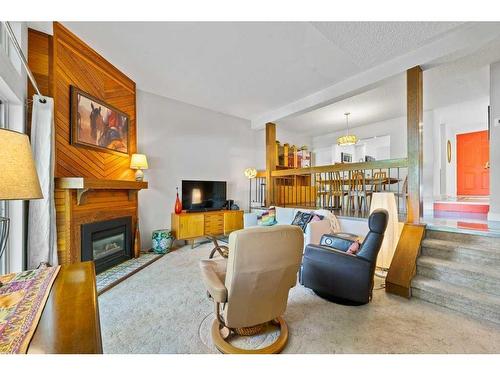 419-3131 63 Avenue Sw, Calgary, AB - Indoor Photo Showing Living Room With Fireplace