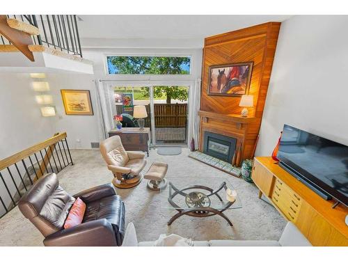 419-3131 63 Avenue Sw, Calgary, AB - Indoor Photo Showing Living Room With Fireplace