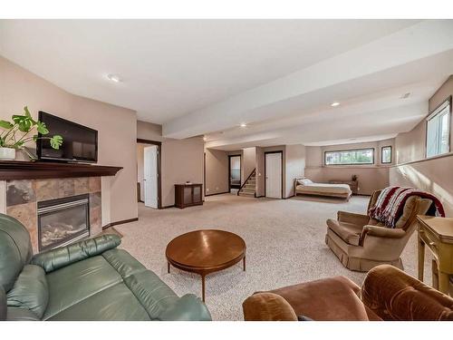 108 Sunset Heights, Crossfield, AB - Indoor Photo Showing Living Room With Fireplace