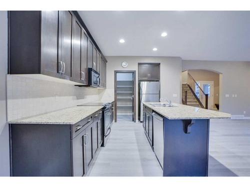 15 Sunset Close, Cochrane, AB - Indoor Photo Showing Kitchen With Upgraded Kitchen