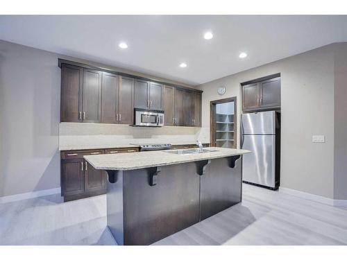 15 Sunset Close, Cochrane, AB - Indoor Photo Showing Kitchen With Upgraded Kitchen