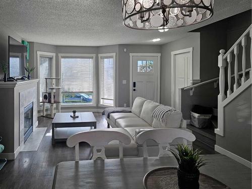 115 Cramond Green Se, Calgary, AB - Indoor Photo Showing Living Room With Fireplace