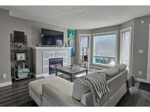 115 Cramond Green Se, Calgary, AB - Indoor Photo Showing Living Room With Fireplace