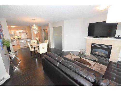 1101-804 3 Avenue Sw, Calgary, AB - Indoor Photo Showing Living Room With Fireplace