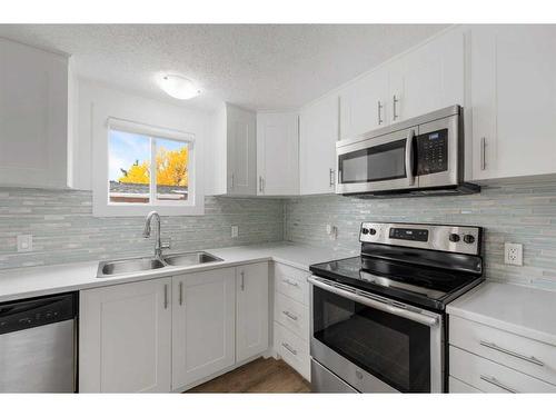 8 Spring Haven Close Se, Airdrie, AB - Indoor Photo Showing Kitchen With Double Sink With Upgraded Kitchen