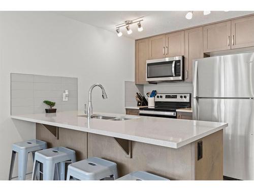 412-338 Seton Circle Se, Calgary, AB - Indoor Photo Showing Kitchen With Double Sink With Upgraded Kitchen