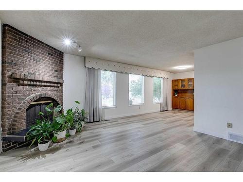 6732 Temple Drive Ne, Calgary, AB - Indoor Photo Showing Other Room With Fireplace