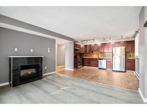 207-429 14 Street Nw, Calgary, AB - Indoor Photo Showing Living Room With Fireplace