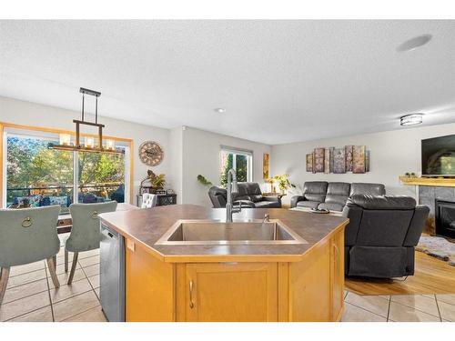 209 Tuscany Ravine Road Nw, Calgary, AB - Indoor Photo Showing Kitchen With Fireplace With Double Sink