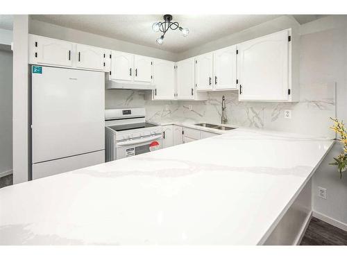 134 Country Hills Villas Nw, Calgary, AB - Indoor Photo Showing Kitchen With Double Sink